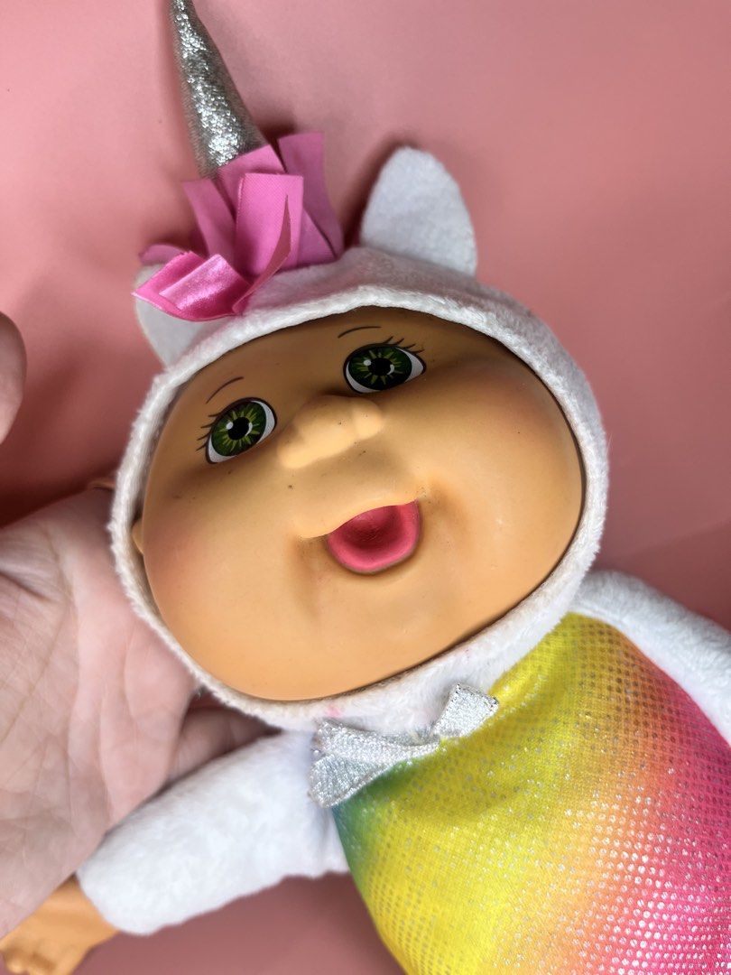CPK Cabbage Patch Kids Unicorn Plush Doll (Category: Plushies & Soft Toys) located in Caloocan City. Submitted by snapshop_ph (Listing ID 1470818608, Image 2). Description: - Authentic Cabbage Patch Kids unicorn plush toy with original CPK fabric tag - Features a sparkly silver horn and bright green eyes - Colorful rainbow glitter belly with pink ribbon mane and tail - White plush body with glittery multicolored hooves - Super soft, clean overall