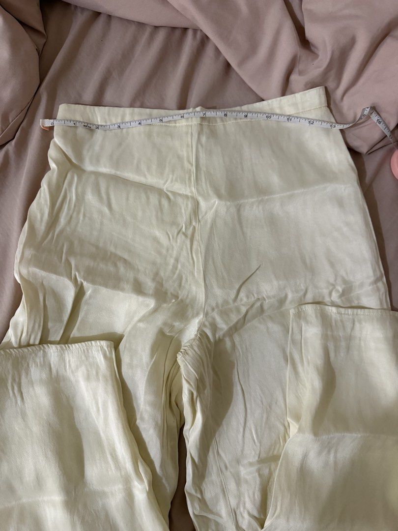 Cream Silk Wide Leg Pants (Category: Jeans) located in Makati City. Submitted by lvshop_mnl (Listing ID 1470879899, Image 3). Description: - Cream wide leg pants in a smooth, light, and flowy satin material - Waist measures approx. 16 inches across flat with a comfy elastic back waistband - Features a convenient side zipper closure - Great basic piece that is easy to dress up or down.