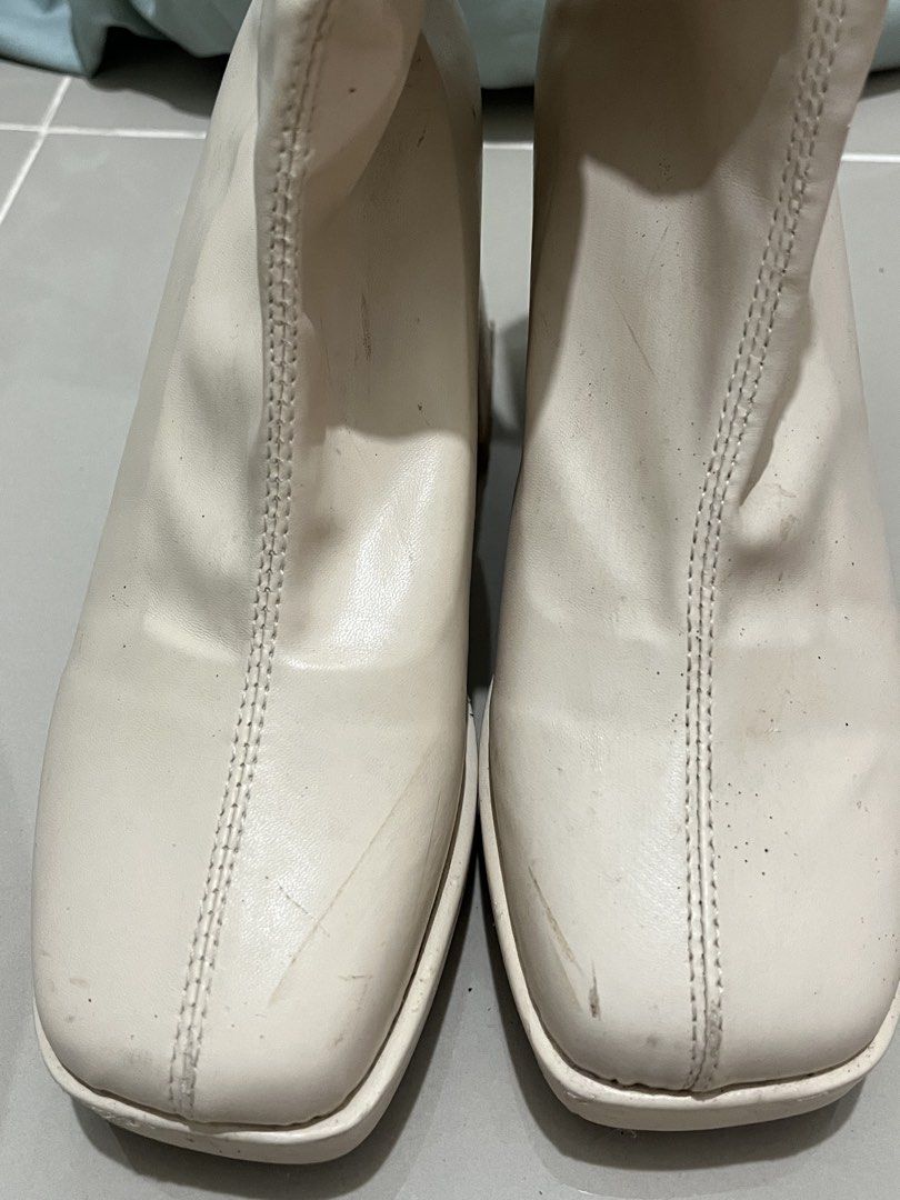 Cream White Chunky Platform Heeled Boots (Category: Boots) located in Taguig. Submitted by m.listings (Listing ID 1470857989, Image 3). Description: Wore this on Eras Tour in SG, worn out because of long hours of standing and walking. Please manage expectations. - Perfect for parties and costumes - Color: Cream white - Style: Ankle boots with chunky heels and platform - Details: Square toe and front seam design - Closure: Side zipper for easy wea