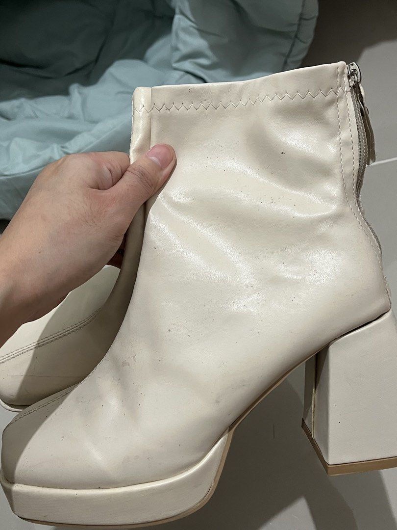 Cream White Chunky Platform Heeled Boots (Category: Boots) located in Taguig. Submitted by m.listings (Listing ID 1470857989, Image 2). Description: Wore this on Eras Tour in SG, worn out because of long hours of standing and walking. Please manage expectations. - Perfect for parties and costumes - Color: Cream white - Style: Ankle boots with chunky heels and platform - Details: Square toe and front seam design - Closure: Side zipper for easy wea