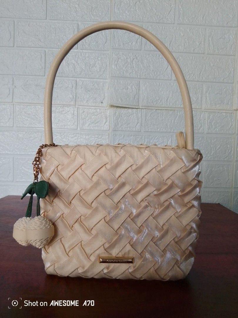 Cream Woven Handbag with Cherry Charm (Category: Shoulder Bags) located in Manila. Submitted by littlelove25 (Listing ID 1470923091, Image 1). Description: - Color: Cream with a trendy glossy finish - Material/Design: Stylish woven texture - Handle: Single rigid top handle for easy carrying - Accessories: Includes an adorable matching cherry charm on a side chain - Details: Small gold-tone metal plaque on the front - Closure: Secure zip-top closu