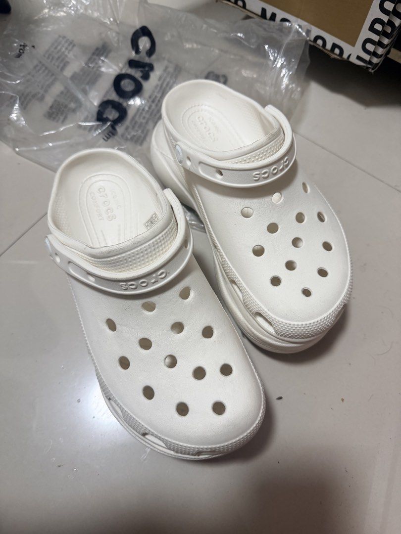 Crocs Classic Platform Clogs White W8 (Category: Slippers and slides) located in Marikina City. Submitted by ukayshopping (Listing ID 1470824328, Image 2). Description: - Item: White Crocs Platform Clogs - Size: Women's US 8 - Design: Iconic comfort, ventilation ports, and debossed brand lettering on heel strap - Origin: Made in Vietnam - Condition: Brand new, with minor dirt marks on soles and heel edges due to handling -Premium Copy.