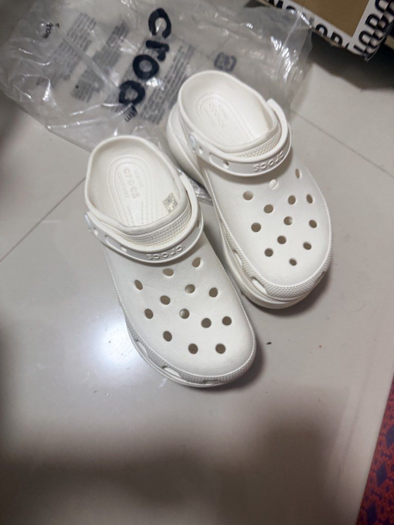 Crocs Classic Platform Clogs White W8 (Category: Slippers and slides) located in Marikina City. Submitted by ukayshopping (Listing ID 1470824328, Image 1). Description: - Item: White Crocs Platform Clogs - Size: Women's US 8 - Design: Iconic comfort, ventilation ports, and debossed brand lettering on heel strap - Origin: Made in Vietnam - Condition: Brand new, with minor dirt marks on soles and heel edges due to handling -Premium Copy.