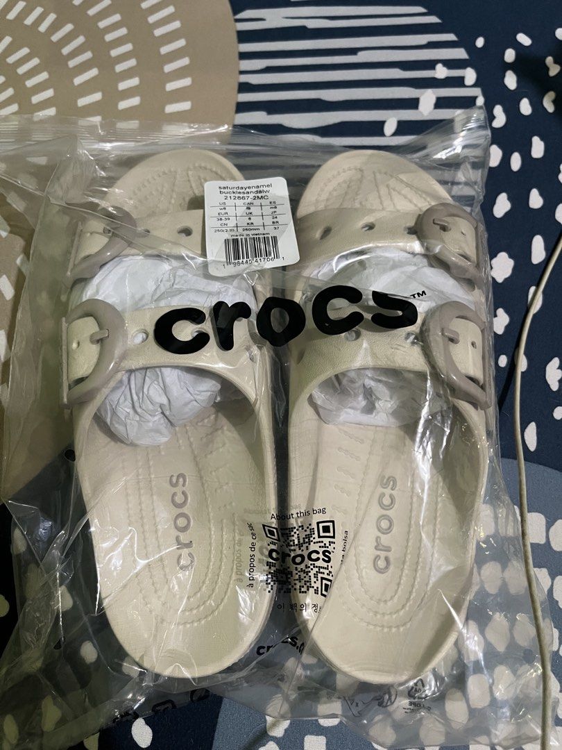 Crocs Saturday Enamel Buckle Sandals (Category: Flats & Sandals) located in Antipolo. Submitted by yosuke88 (Listing ID 1470765073, Image 1). Description: Brand: Crocs Style: Saturday Enamel Buckle Sandals Color: Frappe Size: W8 Condition: Brand new, unworn with tags Features: Double strap design, adjustable enamel buckles, side ventilation holes, and molded footbed Message me for more inquiries and pictures..