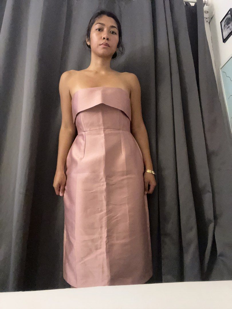 Custom Strapless Pink Midi Dress Gown (Category: Dresses) located in Paranaque City. Submitted by closetcore (Listing ID 1470825947, Image 2). Description: - Brand: June 12 The Label (Custom-made) - Condition: Brand new with tags, never worn - Color: Beautiful pink - Style: Minimalist strapless midi dress - Details: Structured bodice with a folded neckline - Custom clothing tag attached.