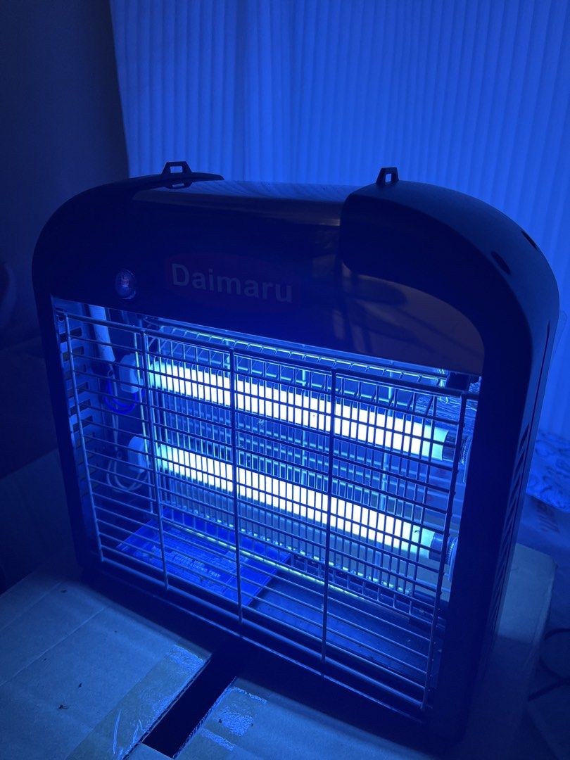 Daimaru Electronic Insect Killer Bug Zapper (Category: Pest Control) located in Manila. Submitted by curated.clutter12 (Listing ID 1470891532, Image 1). Description: - Brand: Daimaru Insect Killer Unit - Condition: Fully powered on with bright dual UV blue light tubes - Design: Sleek black and metallic silver with protective safety grids - Maintenance: Includes a removable bottom tray for efficient bug collection - Installation: Pre-installed han
