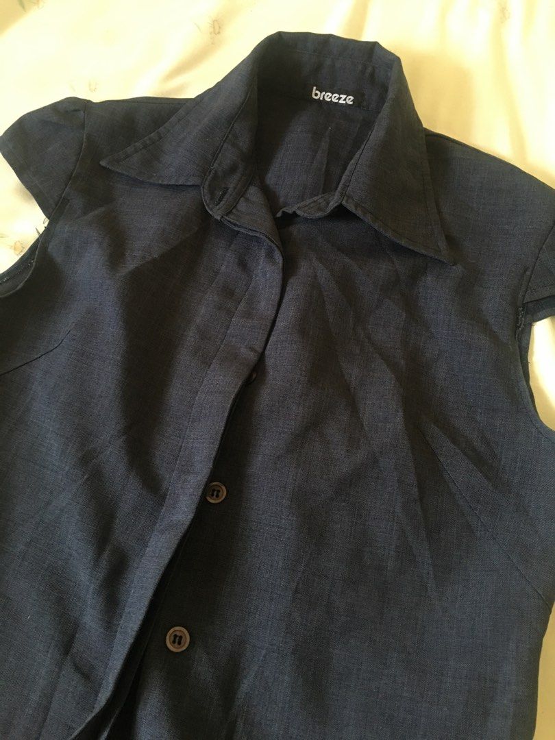 Dark blue collared blouse cap sleeves (Category: Blouses) located in Cabuyao City. Submitted by 4everblooms (Listing ID 1470794257, Image 3). Description: - Fit: Tailored body with cap-style short sleeves - Fabric: Lightweight with a visible textured weave - Versatility: Ideal for office wear or casual outings, easy to pair with slacks or skirts.