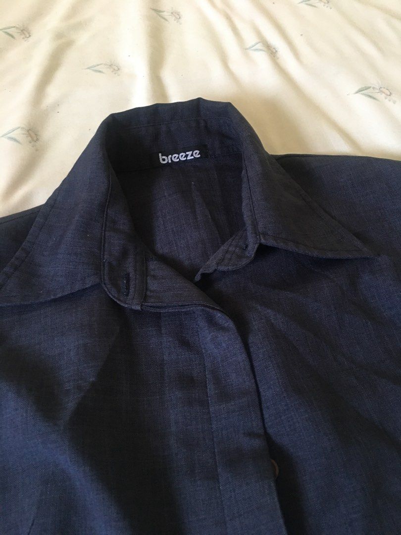 Dark blue collared blouse cap sleeves (Category: Blouses) located in Cabuyao City. Submitted by 4everblooms (Listing ID 1470794257, Image 2). Description: - Fit: Tailored body with cap-style short sleeves - Fabric: Lightweight with a visible textured weave - Versatility: Ideal for office wear or casual outings, easy to pair with slacks or skirts.