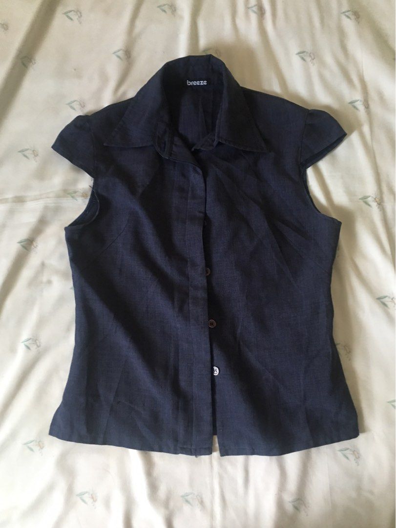 Dark blue collared blouse cap sleeves (Category: Blouses) located in Cabuyao City. Submitted by 4everblooms (Listing ID 1470794257, Image 1). Description: - Fit: Tailored body with cap-style short sleeves - Fabric: Lightweight with a visible textured weave - Versatility: Ideal for office wear or casual outings, easy to pair with slacks or skirts.