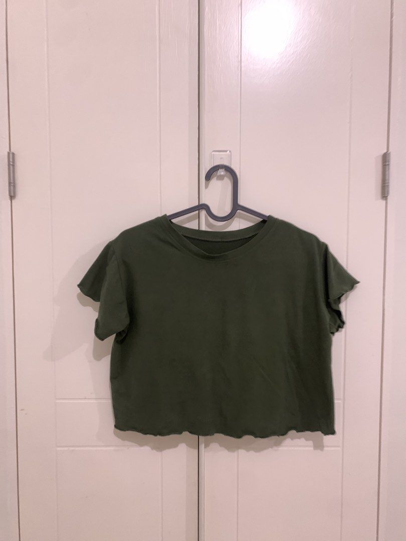 Dark Green Lettuce Hem Crop Top (Category: Sleeveless) located in Pasig City. Submitted by lovedbyri (Listing ID 1470871600, Image 1). Description: - Color: Dark Green - Style: Short-sleeve crop top with classic crew neck - Detail: Charming lettuce trim along the neckline and hemline - Fit: Perfect for pairing with high-waisted jeans or skirts - Comfort: Soft fabric ideal for daily wear - Condition: Clean and well-maintained.