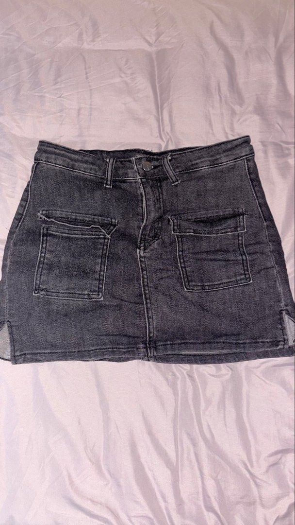 Dark grey denim cargo skort (Category: Skirts) located in Quezon City. Submitted by shrlane (Listing ID 1470889363, Image 1). Description: - Color/Wash: Dark grey acid wash - Size: L (tagged) but best fit 27-28waist - Fit: High-waisted with built-in shorts underneath - Details: Front patch pockets, front button closure, raw style finish - Style: Great staple piece for casual everyday outfits.