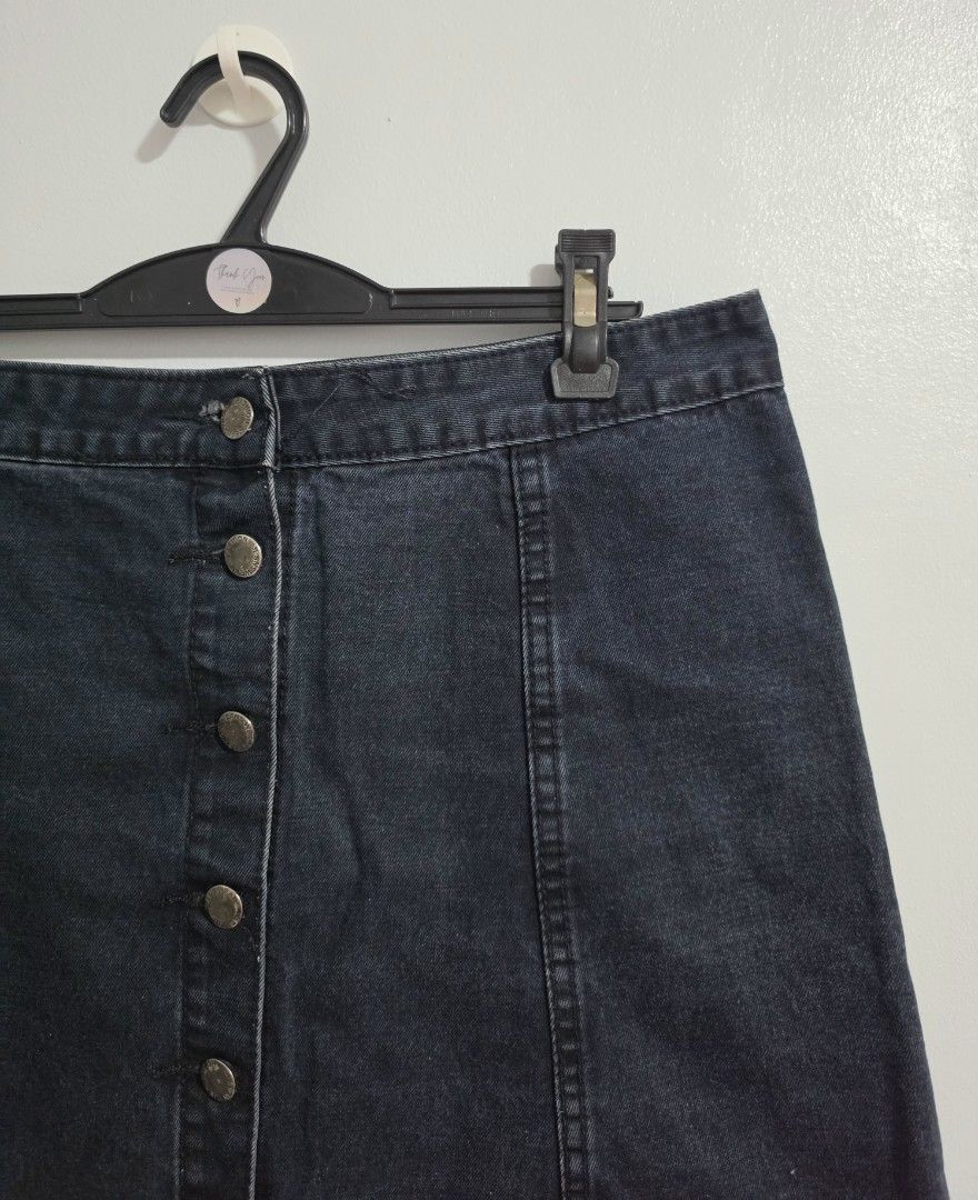 Dark wash denim mini skirt with front buttons (Category: Skirts) located in Paranaque City. Submitted by franinnashop (Listing ID 1470794905, Image 2). Description: Declutter - Style: Dark wash denim mini skirt with vertical seam detailing - Closure: Front button-up with metallic buttons - Measurements: Waist 33 inches, Hips 40 inches, Length 17 inches - Condition: Clean fabric with minimal signs of wear - Versatility: Easy to style with casual t