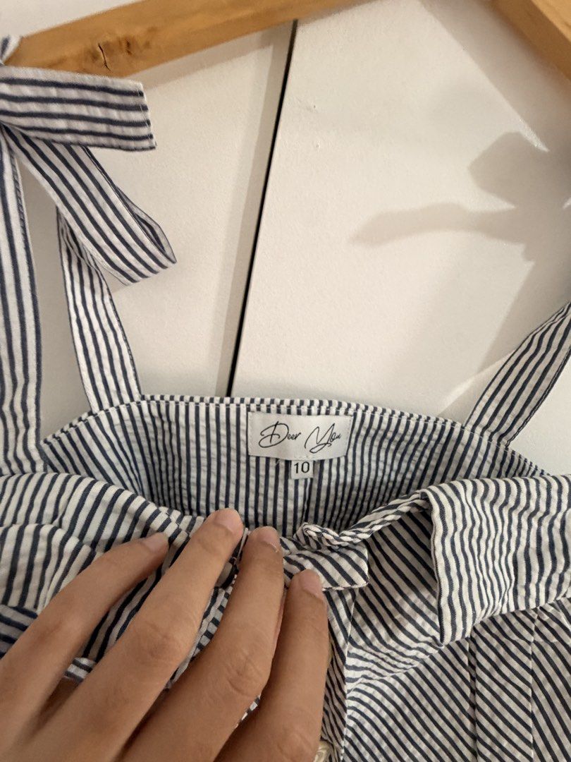Dear You Blue Striped Bow Crop Top Size 10 (Category: Blouses) located in Marikina City. Submitted by _bananahanaa (Listing ID 1470765619, Image 2). Description: - Brand: Dear You - Size: 10, fits med-large - Pattern: Blue and white stripes - Details: Button-down front with 5 white buttons, self-tie shoulder straps, foldover bust detail - Fit: Cropped length, ideal with high-waisted shorts or skirts.