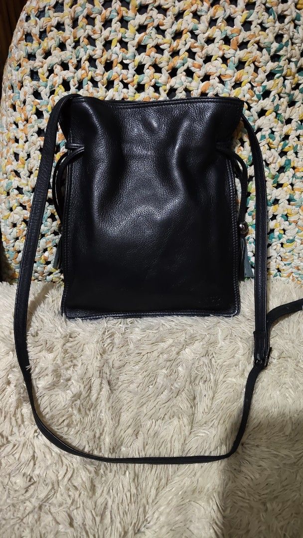 Deco...Black Leather Drawstring Crossbody Bag with Tassels (Category: Cross-body Bags) located in Cebu City. Submitted by lumaynojes00490 (Listing ID 1470825844, Image 2). Description: - Color & Material: Classic black with soft textured leather grain - Closure & Hardware: Drawstring closure with sleek round silver-tone accents - Details: Trendy side tassels on pull cords and a structured square bottom base - Strap: Adjustable thin leather should