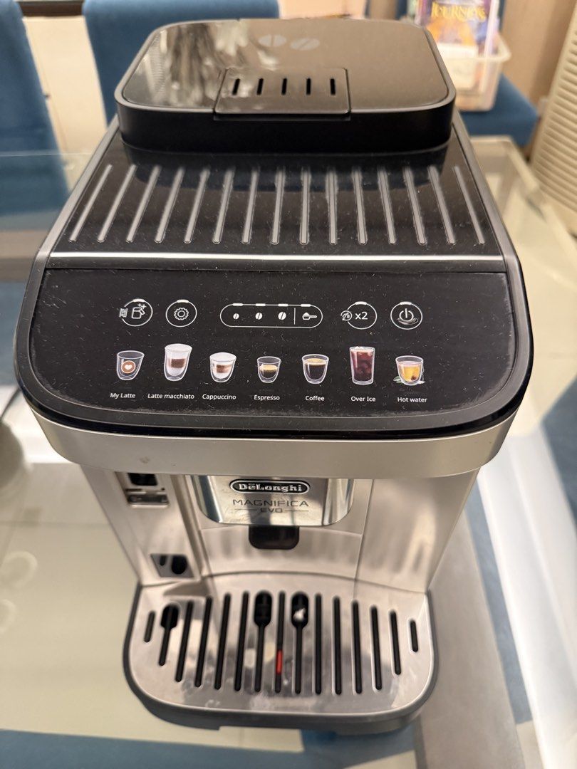 DeLonghi Magnifica Evo Coffee 110 volts (Category: Coffee Machines & Makers) located in Taguig. Submitted by superbshops.ph (Listing ID 1470833090, Image 1). Description: - Model: DeLonghi Magnifica Evo Espresso Machine - Color: Sleek Silver and Black - Control Panel: Intuitive touch panel with 7 presets (My Latte, Latte Macchiato, Cappuccino, Espresso, Coffee, Over Ice, Hot Water) - Included Accessories: Drip tray and top cup warming plate - Con