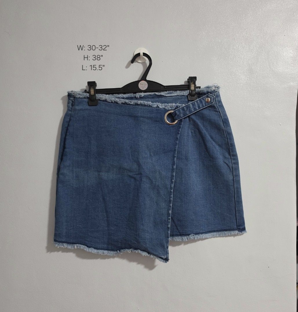 Denim Wrap Skirt with Ring Detail (Category: Skirts) located in Paranaque City. Submitted by franinnashop (Listing ID 1470795449, Image 1). Description: Declutter issue last photo - Style: Blue denim wrap skirt with a trendy raw frayed hem and side zipper closure - Details: Features a decorative waist strap with a silver-tone ring and snap button - Measurements: Waist 30-32 inches | Hips 38 inches | Length 15.5 inches - Condition: Noticeable fadi