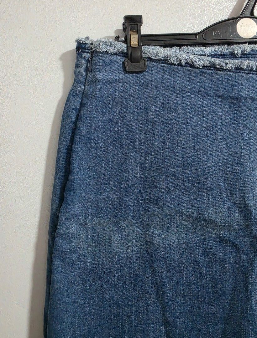 Denim Wrap Skirt with Ring Detail (Category: Skirts) located in Paranaque City. Submitted by franinnashop (Listing ID 1470795449, Image 3). Description: Declutter issue last photo - Style: Blue denim wrap skirt with a trendy raw frayed hem and side zipper closure - Details: Features a decorative waist strap with a silver-tone ring and snap button - Measurements: Waist 30-32 inches | Hips 38 inches | Length 15.5 inches - Condition: Noticeable fadi