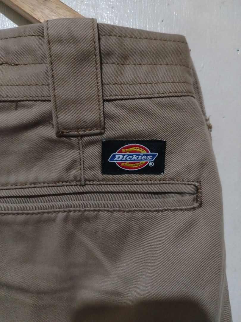 Dickies Cargo Pants Khaki Workwear (Category: Trousers) located in Rizal. Submitted by gmpastoffi75031 (Listing ID 1470800983, Image 3). Description: - Brand: Dickies - dimes waist 35 length 42.5 leg opening 11 - Color: Khaki brown - Material: Heavy-duty cotton twill - Pockets: Multiple utility pockets on sides and back with snap closures - Details: Branded metal button waist, reinforced knee panels, and adjustable drawstring ankles - Branding: I