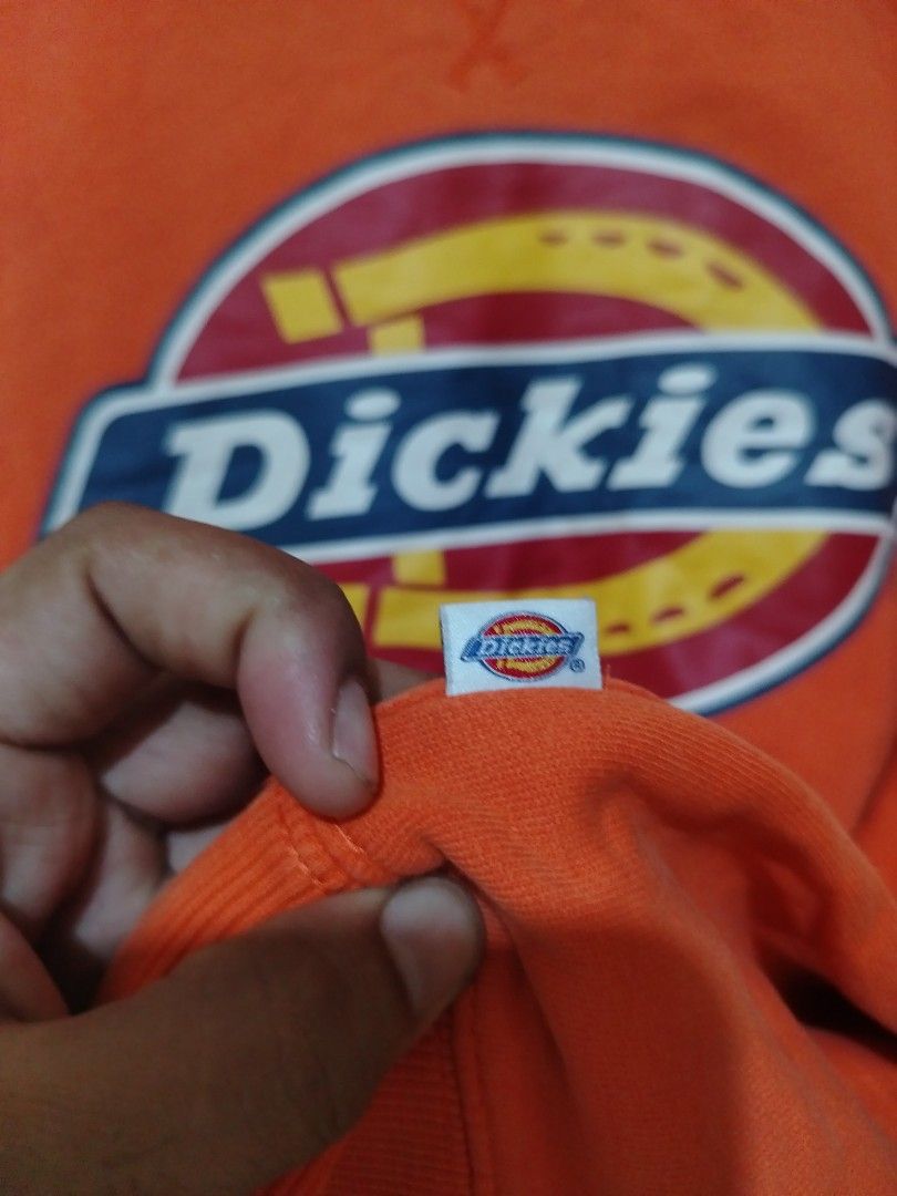 Dickies Orange Logo Sweatshirt (Category: Coats, Jackets and Outerwear) located in Rizal. Submitted by gmpastoffi75031 (Listing ID 1470790831, Image 3). Description: - Brand: Dickies - dimes 24x28 - Color: Bright orange - Size: XL - Material: Thick, warm cotton fleece - Design: Iconic chest logo graphic and classic V-stitch collar - Fit: Ribbed cuffs and hem to maintain shape - Condition: Ready to wear with minor wrinkling from storage.