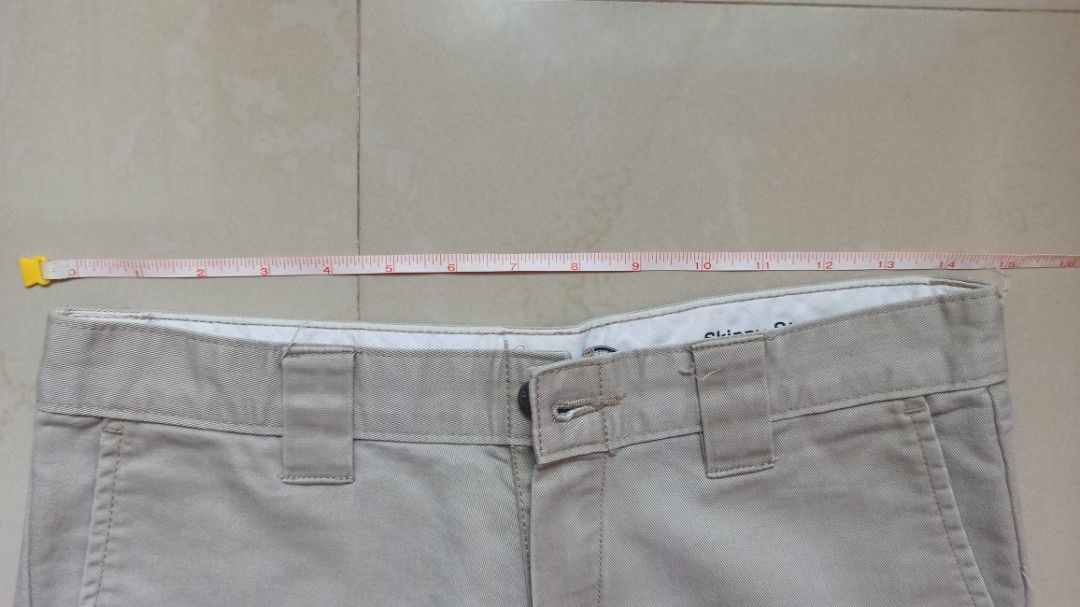 Dickies Skinny Straight Beige Pants (Category: Jeans) located in Santa Teresita. Submitted by icecandy2.0 (Listing ID 1470824187, Image 2). Description: - Brand: Dickies - Style: Skinny straight trousers / Workwear - Color: Beige - Waist: Approx. 15 inches across - Details: Belt loops, zip fly, button closure, signature logo labeling inside waistband - Condition: Good overall, with a small rip near the upper leg area.