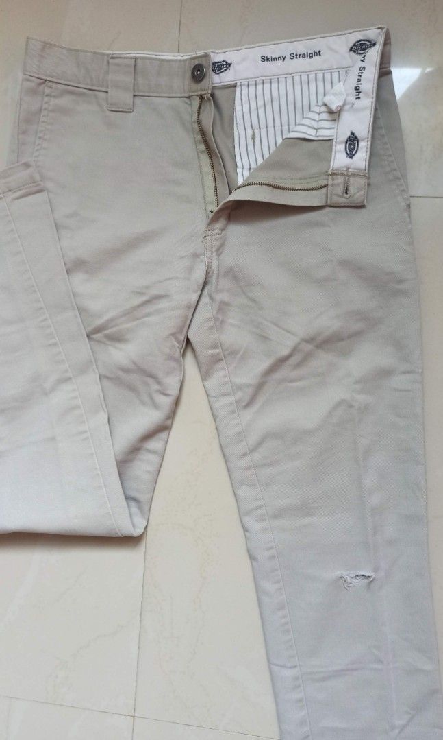 Dickies Skinny Straight Beige Pants (Category: Jeans) located in Santa Teresita. Submitted by icecandy2.0 (Listing ID 1470824187, Image 1). Description: - Brand: Dickies - Style: Skinny straight trousers / Workwear - Color: Beige - Waist: Approx. 15 inches across - Details: Belt loops, zip fly, button closure, signature logo labeling inside waistband - Condition: Good overall, with a small rip near the upper leg area.
