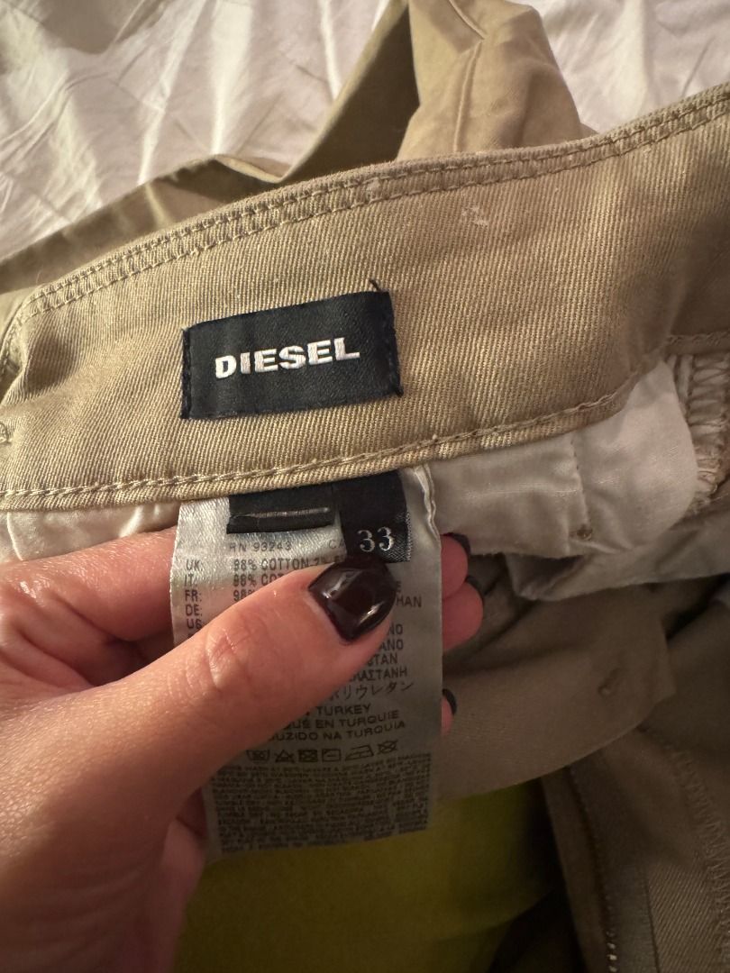 Diesel Khaki Chinos Size 33 (Category: Chinos) located in Cebu City. Submitted by _t.rix (Listing ID 1470762355, Image 2). Description: - Brand: Diesel - Color: Khaki / Clean neutral - Cut: Classic slim straight - Size: Tagged size 33 - Material: 98% cotton, 2% elastane for a comfortable stretch - Features: Back welt pockets with button closure and branded hardware detailing - Condition: Versatile everyday wardrobe staple.