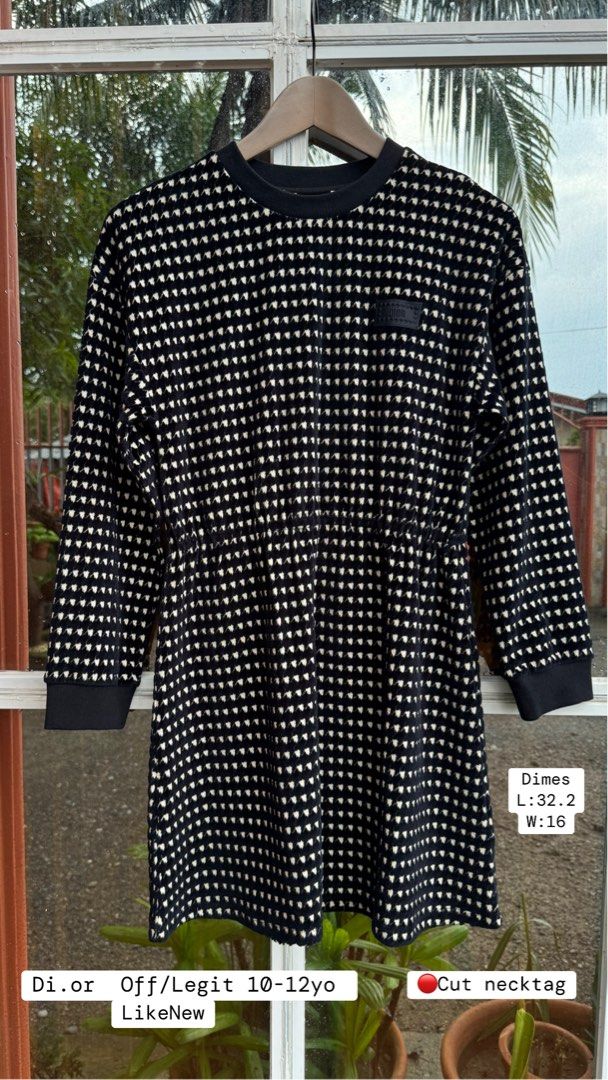 Dior Black and White Pattern Dress 10-12yo (Category: Announcements) located in Pozorrubio. Submitted by izaykite2g (Listing ID 1470763647, Image 1). Description: - Style: Black and white patterned dress for kids - Size: Fits ages 10 to 12 years old (Length: 32.2", Width: 16") - Design: Long sleeves, round ribbed neckline, and a flattering elastic waist - Detail: Features a cute small DIOR logo patch on the chest - Condition: Cut neck tag.