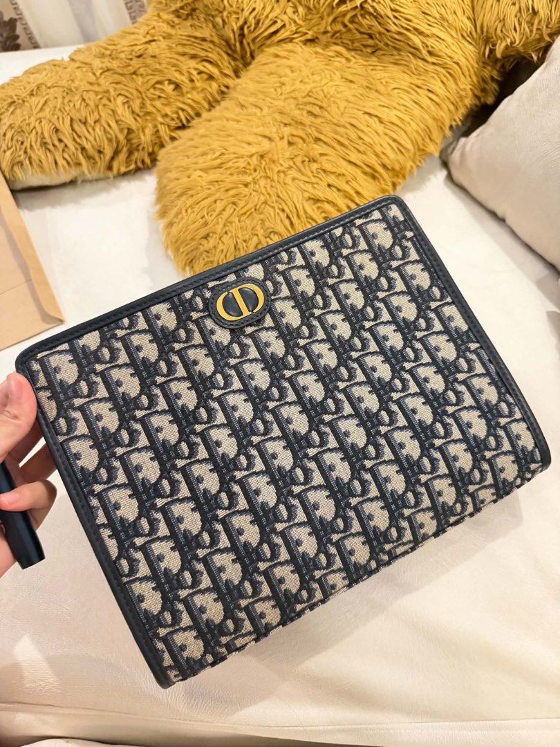Dior Oblique Jacquard Clutch Pouch Blue (Category: Luxury Bags & Wallets) located in Marikina City. Submitted by giopoquiz (Listing ID 1470928814, Image 1). Description: - Authentic Dior pouch in iconic blue Oblique jacquard canvas with dark leather trim and gold CD hardware - No Box - 9.5/10 Condition .