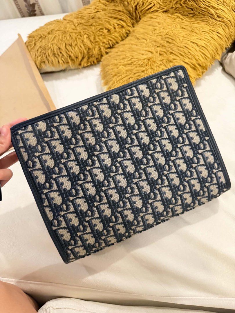 Dior Oblique Jacquard Clutch Pouch Blue (Category: Luxury Bags & Wallets) located in Marikina City. Submitted by giopoquiz (Listing ID 1470928814, Image 2). Description: - Authentic Dior pouch in iconic blue Oblique jacquard canvas with dark leather trim and gold CD hardware - No Box - 9.5/10 Condition .