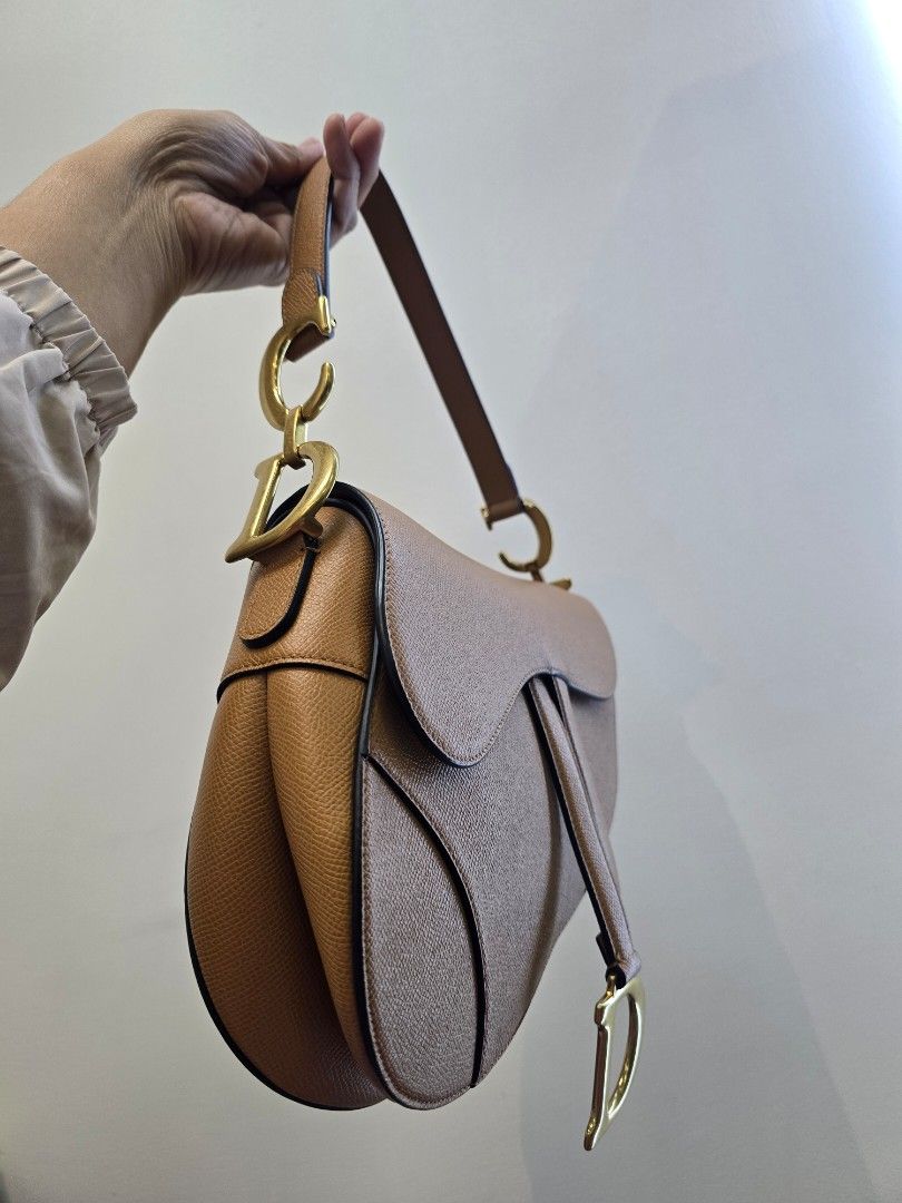 Dior Saddle Medium Golden Camello Bag (Category: Luxury Bags & Wallets) located in Taguig. Submitted by mluxeph (Listing ID 1470788668, Image 3). Description: Dior Saddle Medium Golden Camello Bag Material: Grained calfskin leather Stamp: 09 MA 0271 Year: 2021 Interior: One zip pocket and one main compartment Measurements: 10”L X 2.5”W X 8”H Handle Drop: 7" Hardware: Gold tone Inclusions: Original box, original dust bag and care booklet.