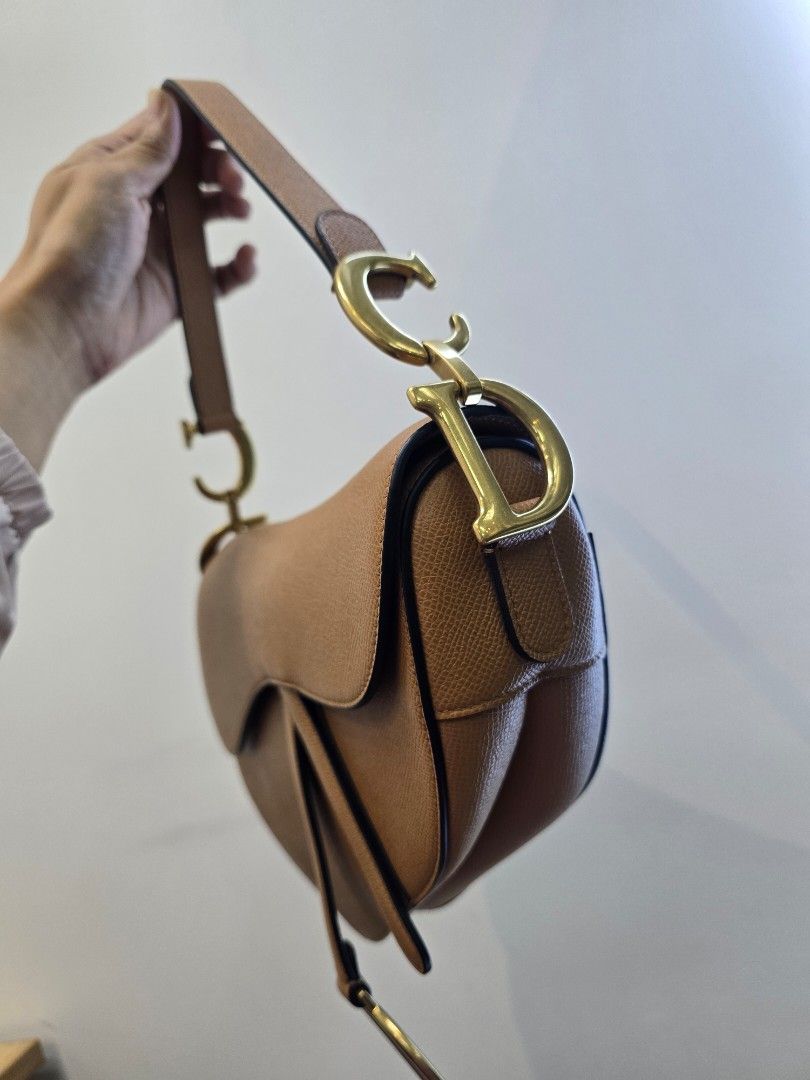 Dior Saddle Medium Golden Camello Bag (Category: Luxury Bags & Wallets) located in Taguig. Submitted by mluxeph (Listing ID 1470788668, Image 2). Description: Dior Saddle Medium Golden Camello Bag Material: Grained calfskin leather Stamp: 09 MA 0271 Year: 2021 Interior: One zip pocket and one main compartment Measurements: 10”L X 2.5”W X 8”H Handle Drop: 7" Hardware: Gold tone Inclusions: Original box, original dust bag and care booklet.
