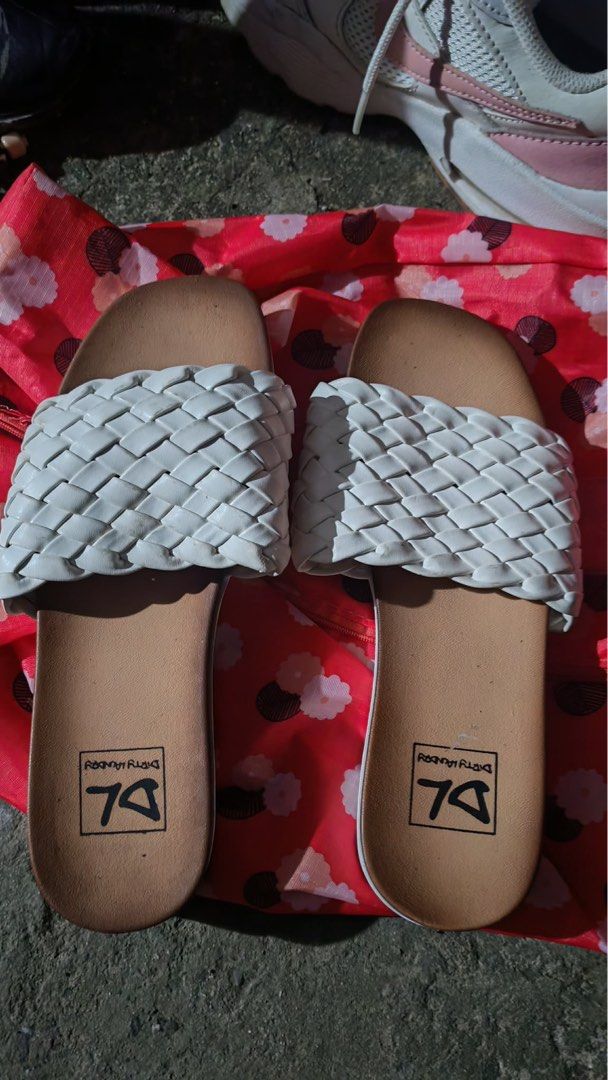 Dirty Laundry White Woven Slide Sandals (Category: Flats & Sandals) located in Baguio. Submitted by markmartin3 (Listing ID 1470886036, Image 2). Description: - Brand: Dirty Laundry - Style: Slip-on platform sandals - Color: White woven top strap, tan footbed with black DL logo, and white grooved sole - Condition: Minor wear visible on the bottom treads - Perfect for: Warm weather and easy styling used twice.