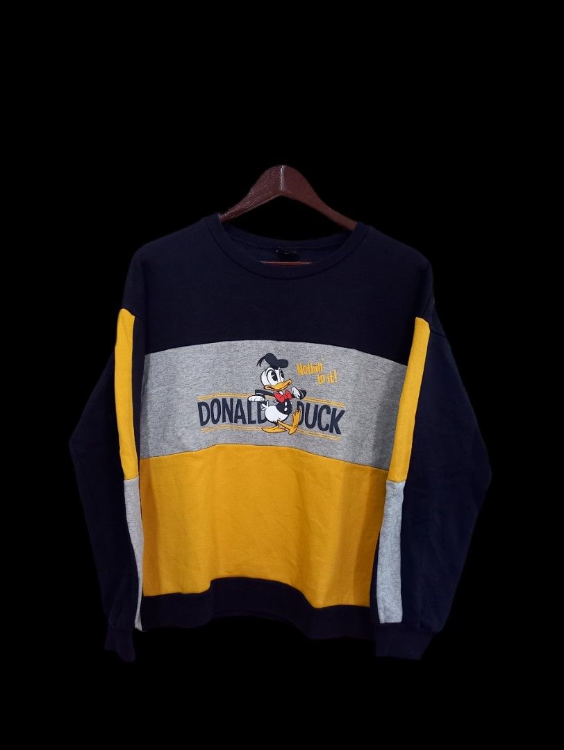 Disney Sweatshirt (Category: Coats, Jackets and Outerwear) located in General Santos City (Dadiangas). Submitted by silvkimber62755 (Listing ID 1470746069, Image 1). Description: - Design: Stylish colorblock in navy blue, grey, and yellow with a large Donald Duck front graphic and 'Nothin to it!' text - Details: Long sleeves with matching yellow and grey arm stripes - Comfort: Thick fleece lining inside with ribbed collar, cuffs, and hem for extr