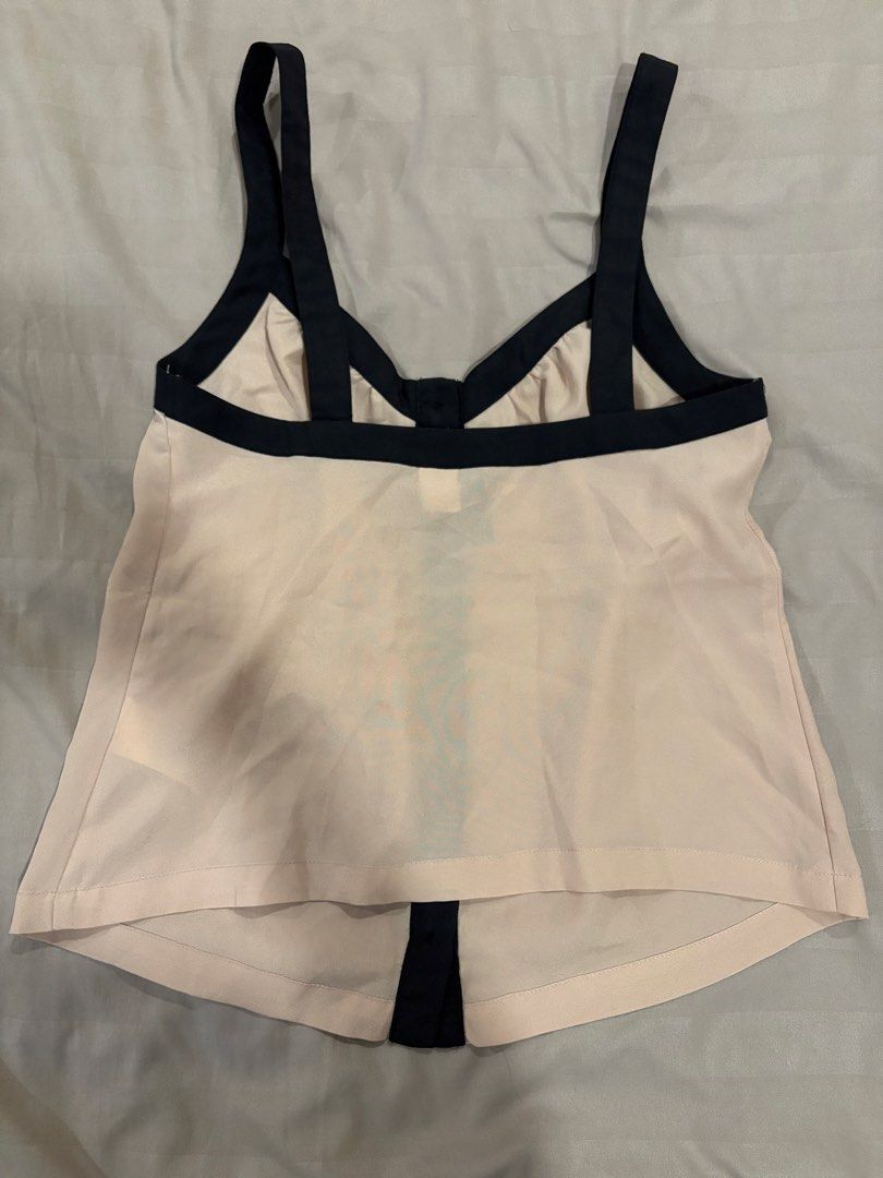 Divided by H&M Beige Black Button Tank Top Size 2 (Category: Sleeveless) located in Pasig City. Submitted by fashionforward16 (Listing ID 1470821060, Image 3). Description: - Brand: Divided by H&M - Style: Sleeveless tank top with full-length front button placket - Color: Beige with contrasting black straps and trim - Material: Lightweight slightly sheer fabric .