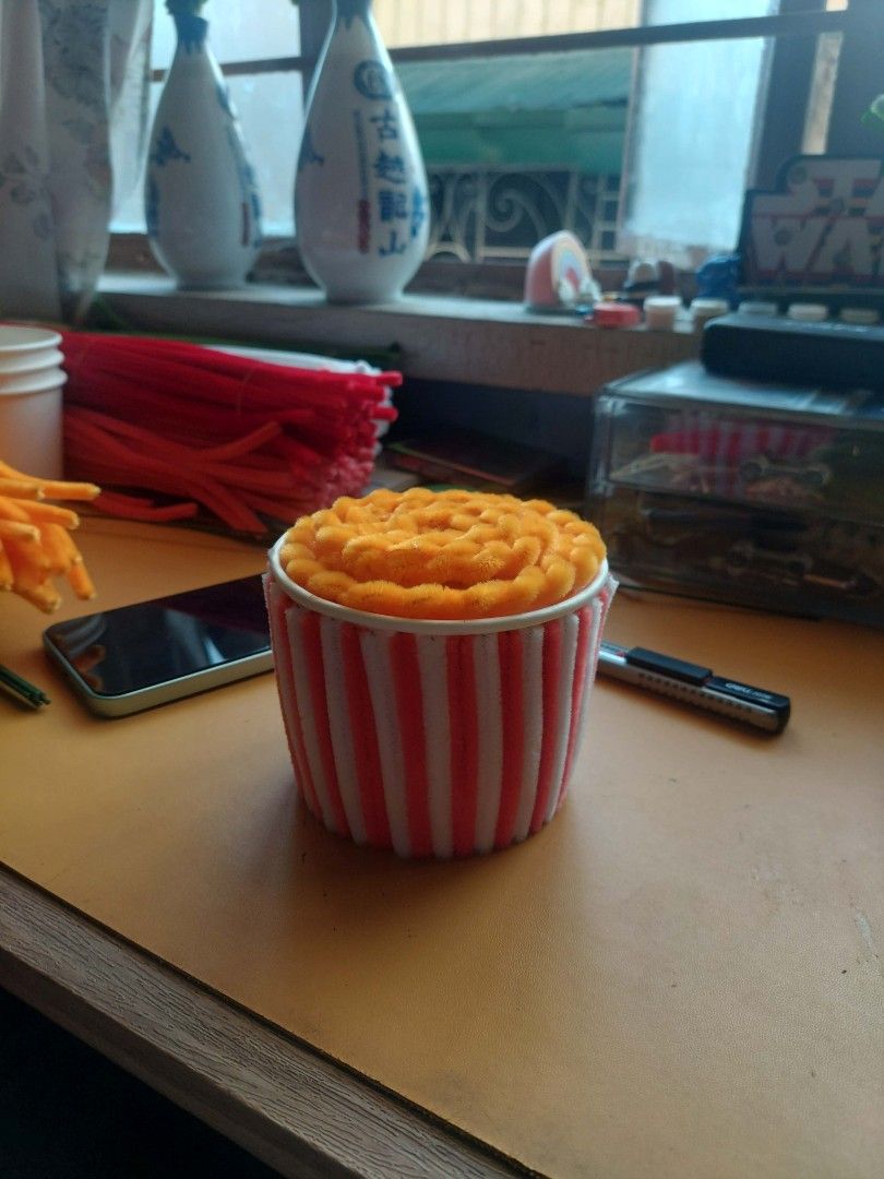 DIY Pipe Cleaner Popcorn Craft Desk Decor (Category: Handmade Craft) located in Manila. Submitted by warmtree_6c8201 (Listing ID 1470764998, Image 1). Description: - Handmade cute popcorn bucket craft - Made entirely from fuzzy pipe cleaner wires - Red and white striped cup with textured yellow popcorn top - Lightweight and compact design - Perfect fun desk ornament or room decor piece.