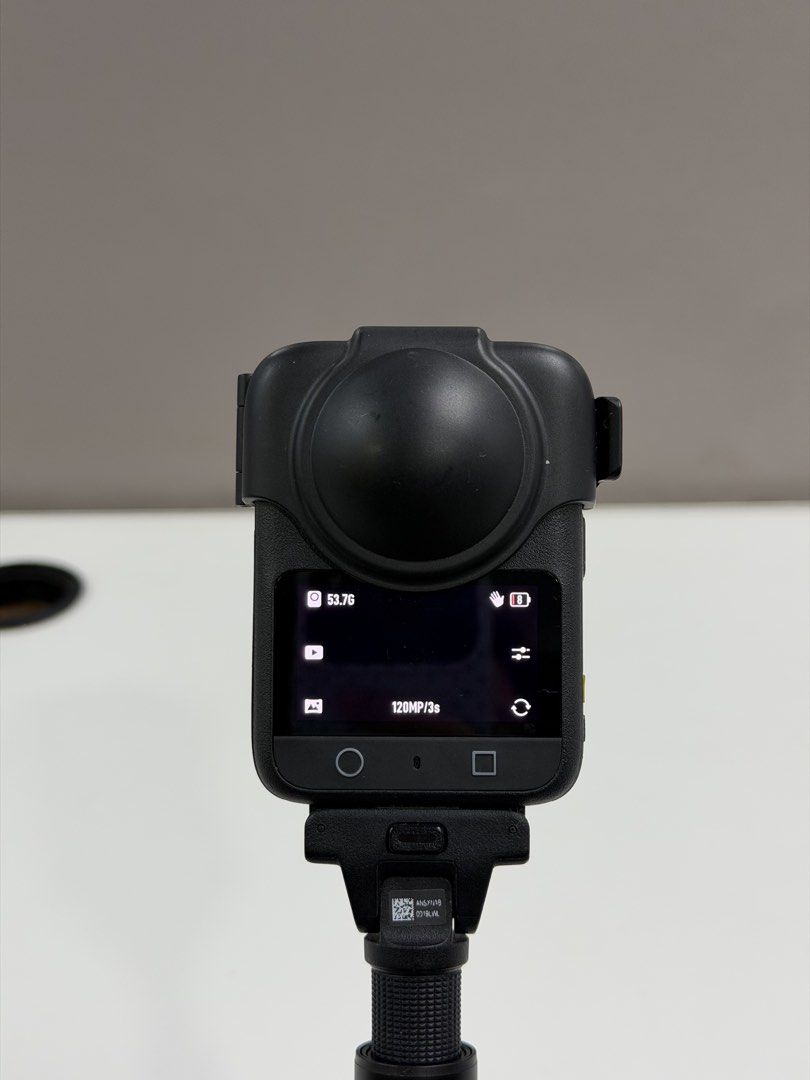 DJI Osmo Action Camera 360 with Extension Rod (Category: Video Cameras) located in Bacoor. Submitted by shopthenrock (Listing ID 1470885020, Image 3). Description: - Model: DJI Osmo Action Camera in sleek black finish - Condition: Fully functional and powered on with an active display - Features: Dual screens and a bulbous lens guard - Inclusion: Comes with an extension rod for better reach - Use: Designed with a gripped handle for steady recordi