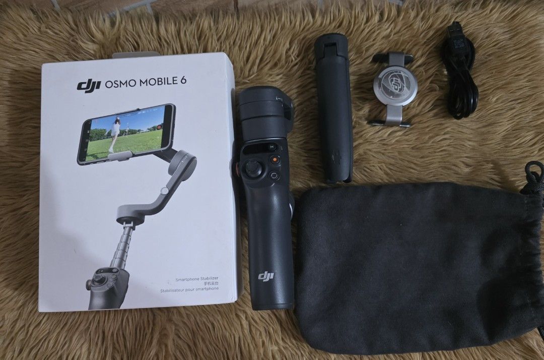 DJI Osmo Mobile 6 Handheld Gimbal (Category: Other Gadgets) located in Lipa City. Submitted by pugnerd25 (Listing ID 1470838017, Image 2). Description: DJI Osmo Mobile 6 Handheld Gimbal - ₱5,500 - LP: ₱5K RFS: Decluttering Pick up ONLY: Casa Feliz Subdivision Brgy Pusil Lipa City Box Content: DJI OM 6, Magnetic Phone Clamp 3, Grip Tripod, Power Cable & Storage Pouch Gimbals & Stablizer Features: Foldable & Portable Brand: DJI Condition: Used like