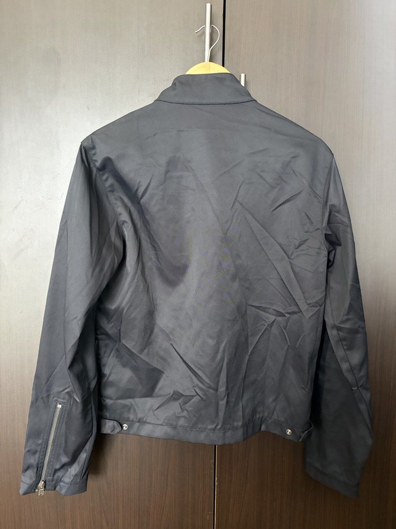 DKNY Black Nylon Cotton Blend Moto Jacket Size S (Category: Coats, Jackets and Outerwear) located in Urdaneta. Submitted by theoldmanstore (Listing ID 1470747480, Image 2). Description: - Brand: DKNY - Style: Moto jacket with minimal hardware - Size: S - Material: 65% nylon, 35% cotton - Color: Black - Features: Diagonal front zipper, stand collar with buckle strap, zip chest pocket, and sleeve zip details.