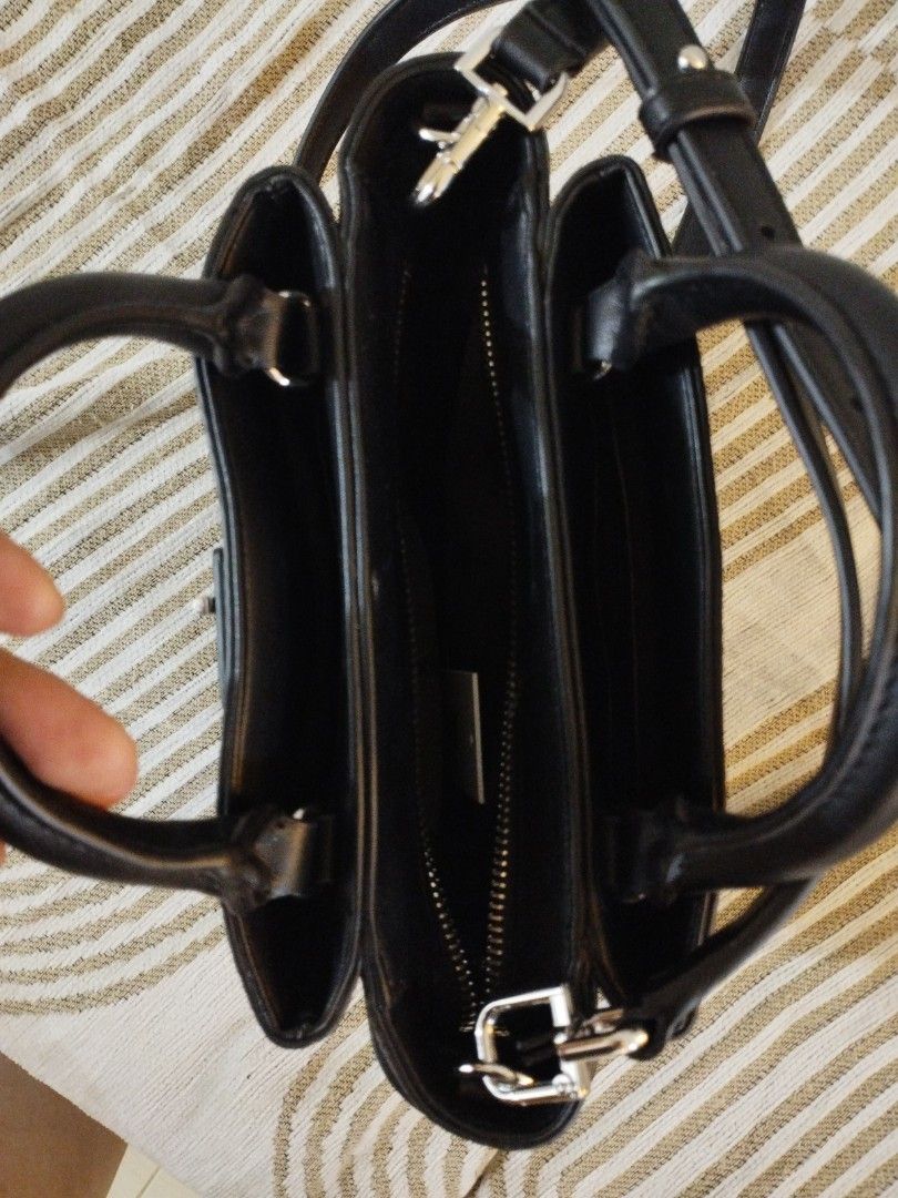 DKNY Onya crossbody bag (Category: Luxury Bags & Wallets) located in Caloocan City. Submitted by shopaholic_cousins (Listing ID 1470876675, Image 3). Description: - Brand: DKNY - Material: Black pebbled faux leather with silver hardware - Condition: Brand new with original Marshalls tag still attached - Closure: Secure twist-lock front flap - Carrying Options: Double top handles & adjustable/removable shoulder strap - Interior: Signature logo lin