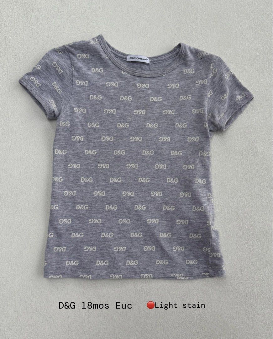 Dolce & Gabbana D&G Gray Monogram T-Shirt 18M (Category: Babies & Kids Fashion) located in Pozorrubio. Submitted by izaykite2g (Listing ID 1470762017, Image 1). Description: - Brand: Dolce & Gabbana Kids - Color: Gray with all-over D&G monogram print - Style: Short sleeves, crew neck - Size: 18 months - Condition: Pre-loved with a light stain (kindly check photos before buying) - Authentic designer wear for less!.