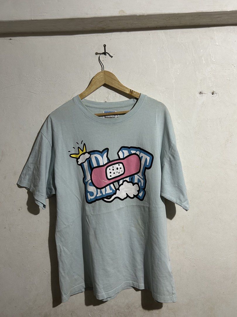 Donsmoke Graphic Tee Light Blue Size L (Category: Tshirts & Polo Shirts ) located in Manila. Submitted by romnick907 (Listing ID 1470819320, Image 1). Description: - Brand: Donsmoke - Color: Light Blue - Size: Large (tag at collar and inner hem) - Design: Large front graphic featuring a crown, cloud, and pink adhesive bandage motif - Material: Clean, high-quality cotton with vibrant screen-print - Condition: Excellent/Ready to wear.
