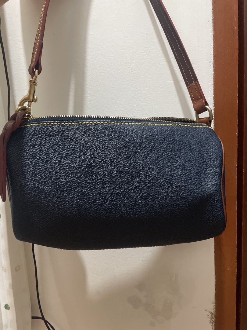 Dooney & Bourke Navy Leather Shoulder Bag (Category: Luxury Bags & Wallets) located in Davao. Submitted by newowl_777 (Listing ID 1470845248, Image 2). Description: - Brand: Dooney & Bourke - Material: Navy blue pebbled leather with brown leather trim - Design details: Contrast yellow stitching and gold-tone metal hardware with lobster clasps - Closure: Secure zip top closure - Branding: Small rectangular gold logo plaque stamped with 1975 on the