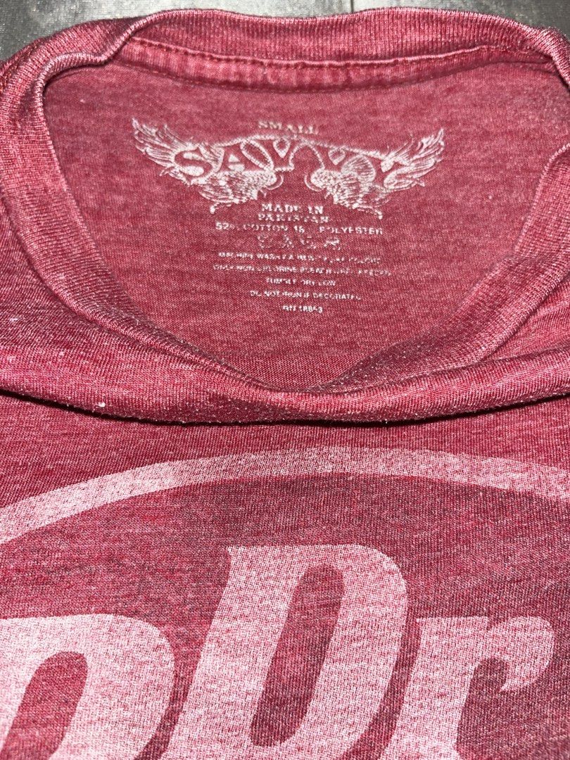 Dr Pepper Distressed Graphic T-Shirt Maroon Small (Category: Tshirts & Polo Shirts ) located in Cebu City. Submitted by cjayyythriftzzz (Listing ID 1470835245, Image 2). Description: - Color: Maroon with a distressed white Dr Pepper chest logo - Material: Comfortable cotton blend fabric - Fit & Feel: Super soft with a normal vintage wash fade - Design: Short sleeves and classic crew neckline - Condition: Tagless collar for extra comfort.