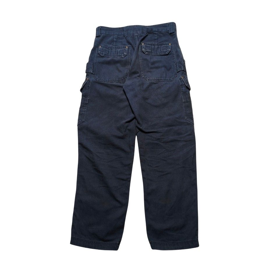 Duluth Trading Co. Dark Navy Cargo Work Pants with Multiple Pockets (Category: Jeans) located in Meycauayan. Submitted by thrifting_gorilla (Listing ID 1470887271, Image 2). Description: Duluth Trading Co. Dark Navy Cargo Work Pants with Multiple Pockets - Color: Dark navy blue - Material: Thick woven canvas fabric with slight fading and natural wear marks - Style: Rugged workwear - Pockets: Multiple utility pockets on both legs and back patch po