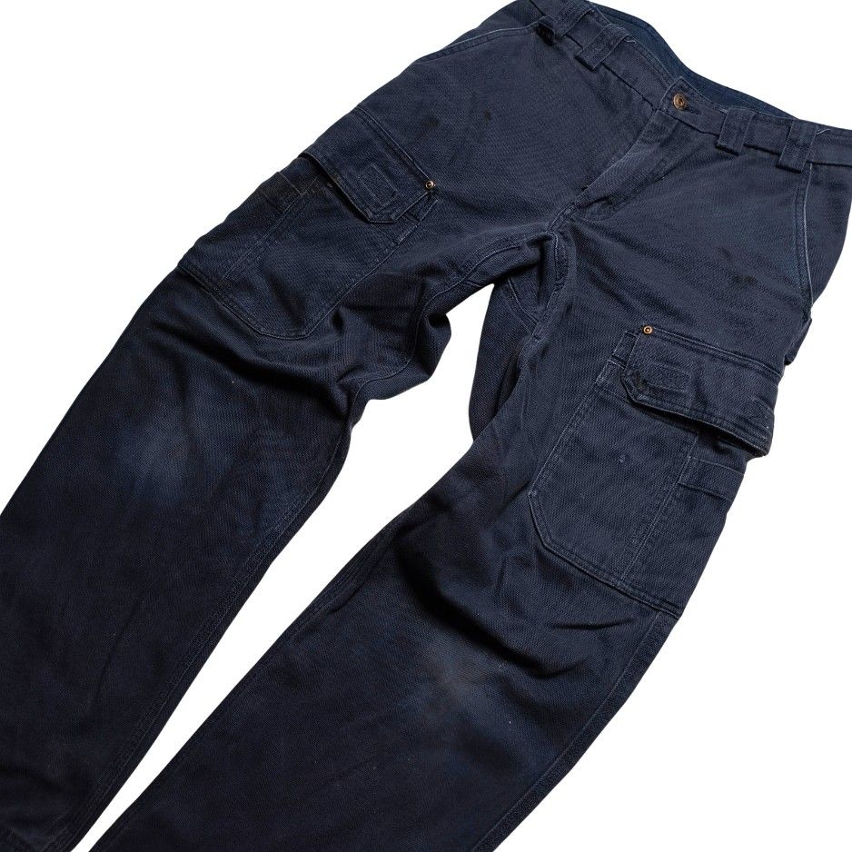 Duluth Trading Co. Dark Navy Cargo Work Pants with Multiple Pockets (Category: Jeans) located in Meycauayan. Submitted by thrifting_gorilla (Listing ID 1470887271, Image 3). Description: Duluth Trading Co. Dark Navy Cargo Work Pants with Multiple Pockets - Color: Dark navy blue - Material: Thick woven canvas fabric with slight fading and natural wear marks - Style: Rugged workwear - Pockets: Multiple utility pockets on both legs and back patch po