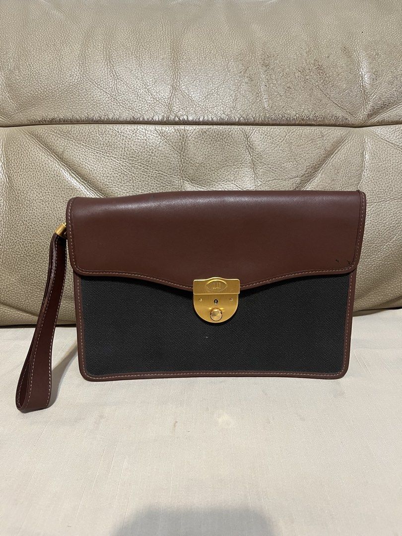 Dunhill Brown and Black Clutch Bag (Category: Clutches) located in Calamba. Submitted by jupreloved_ (Listing ID 1470791790, Image 1). Description: Authentic Dunhill clutch bag in brown leather and black textured fabric. Features a gold-tone lock closure, wrist strap, and green tartan plaid interior with a zippered pocket. Brand: Dunhill Size: Semi-medium Shipping through J&T. Payment are strictly through GCASH only, no COD. Exact size and color 