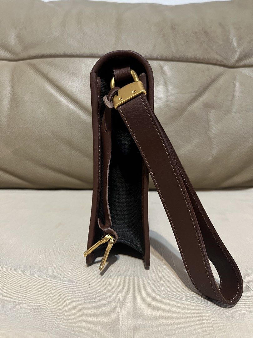 Dunhill Brown and Black Clutch Bag (Category: Clutches) located in Calamba. Submitted by jupreloved_ (Listing ID 1470791790, Image 2). Description: Authentic Dunhill clutch bag in brown leather and black textured fabric. Features a gold-tone lock closure, wrist strap, and green tartan plaid interior with a zippered pocket. Brand: Dunhill Size: Semi-medium Shipping through J&T. Payment are strictly through GCASH only, no COD. Exact size and color 