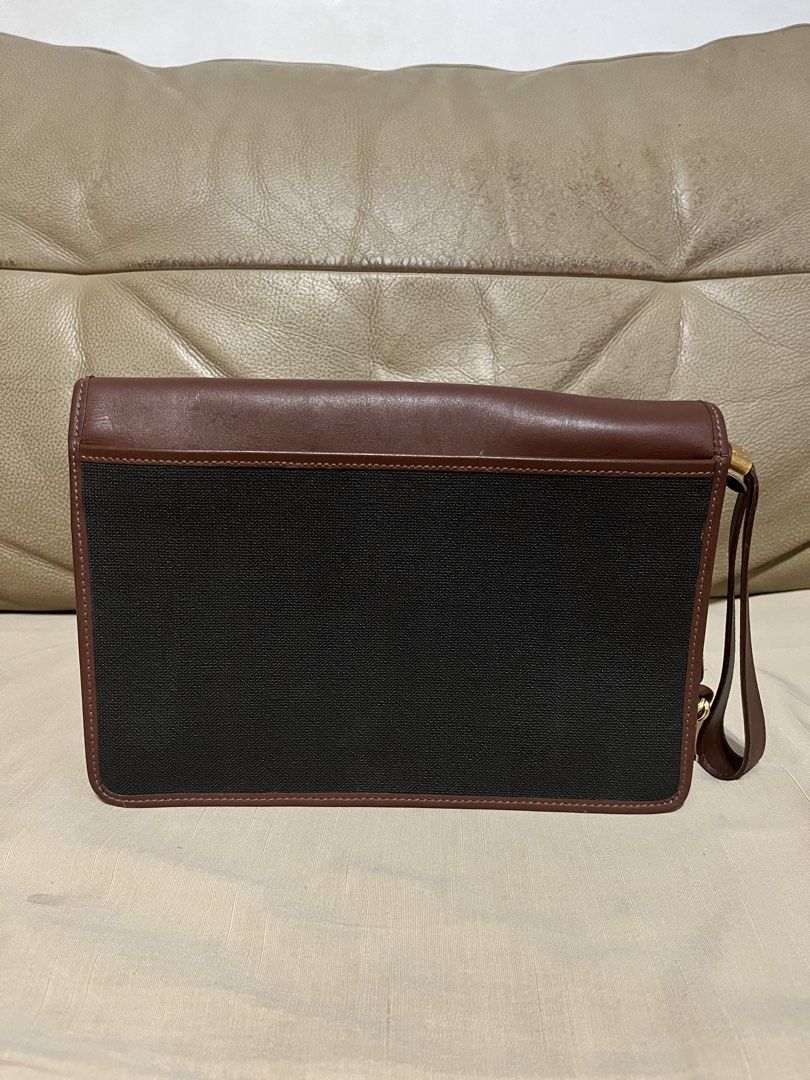 Dunhill Brown and Black Clutch Bag (Category: Clutches) located in Calamba. Submitted by jupreloved_ (Listing ID 1470791790, Image 3). Description: Authentic Dunhill clutch bag in brown leather and black textured fabric. Features a gold-tone lock closure, wrist strap, and green tartan plaid interior with a zippered pocket. Brand: Dunhill Size: Semi-medium Shipping through J&T. Payment are strictly through GCASH only, no COD. Exact size and color 