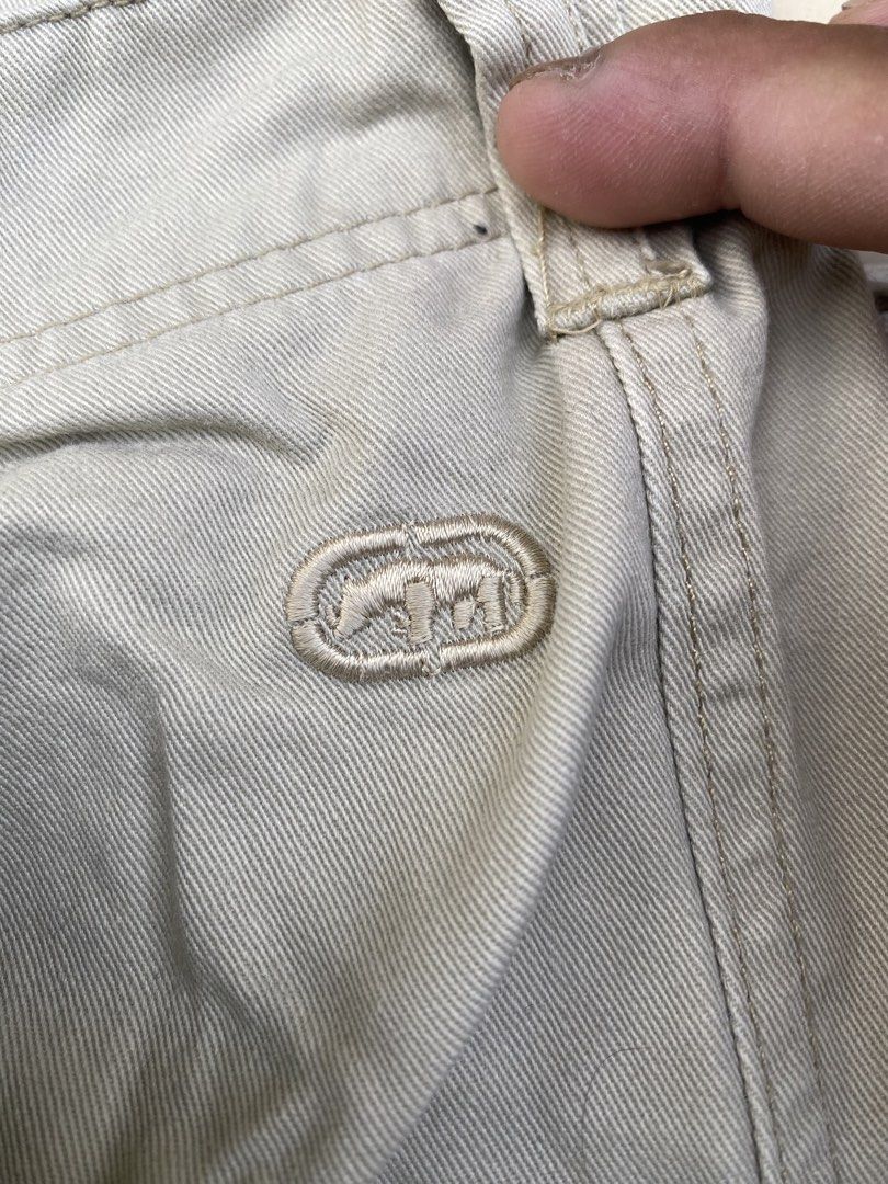 Ecko Unltd Beige Cargo Shorts Multi Pocket (Category: Shorts) located in Imus. Submitted by frootiloots4103 (Listing ID 1470769190, Image 3). Description: - Brand/Item: Ecko Unltd beige cargo shorts - Material: Durable cotton blend, machine washable - Style: Heavy-duty utility with button closure and belt loops - Storage: Multiple functional pockets on sides and back - Details: Signature embroidered rhino logo near the pocket - Condition: Excelle