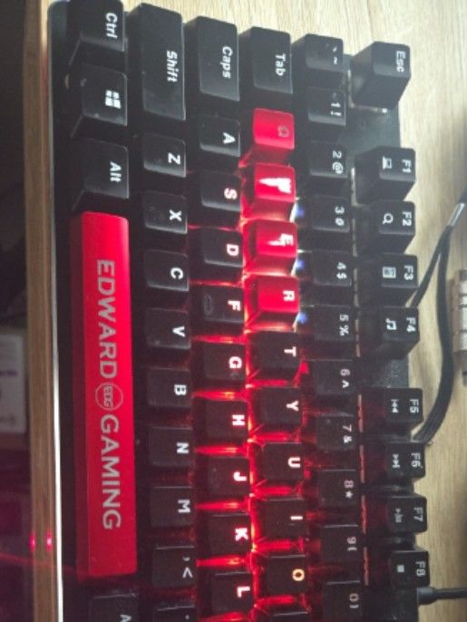 EDG Gaming Mechanical Keyboard with Red Backlight (Category: Computer Keyboard) located in Makati City. Submitted by nategz (Listing ID 1470772321, Image 2). Description: - Type: Tenkeyless (TKL) mechanical gaming keyboard - Lighting: Red LED backlight - Aesthetics: Custom Edward Gaming red keycaps on WASD and spacebar; black body with white legends - Condition: Used with minor dust on the chassis and keycaps - Performance: 100% fully functional,